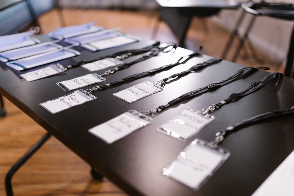 Close-up of name tags and folders laid out for a conference or meeting.